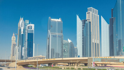 Busy Sheikh Zayed Road timelapse, metro railway and modern skyscrapers around in luxury Dubai city