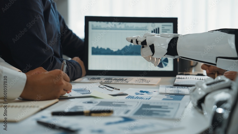 Poster a human and a robot collaborate in a business setting, analyzing data through graphs and charts disp