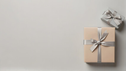 A white background with two boxes on it. The boxes are wrapped in silver ribbons and are placed on top of the white background