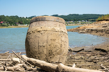 An old wooden barrel revealed at the bottom of a lake when the water level of a reservoir dropped,...
