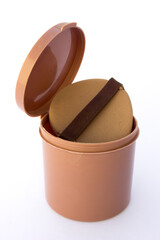 A brown tube container for storing women's powder sponges, isolated on white background.