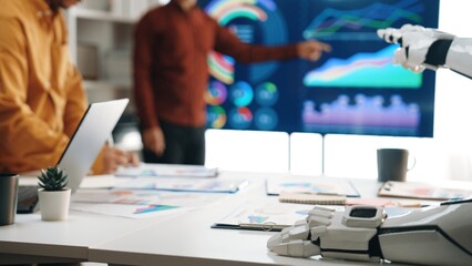 A dynamic business meeting showcases the integration of advanced technology with a robot hand...