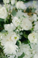 Elegant white floral arrangement with roses and greenery for a serene atmosphere in springtime