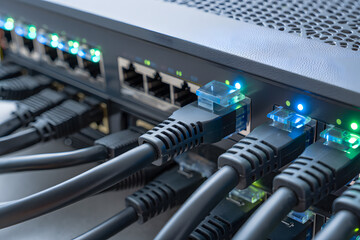 Network Switch Illuminated Ports with Connected Ethernet Cables