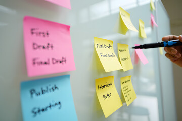 Brainstorming Session with Colorful Sticky Notes and Marker in Hand