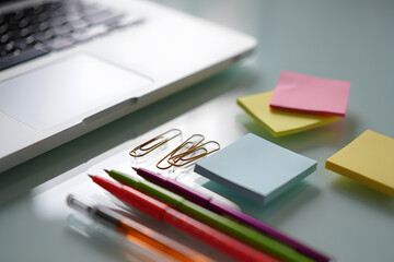 A blank notebook with a pen and pencil rests on an office desk, ready for work or school notes