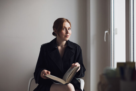 young business woman reading a book