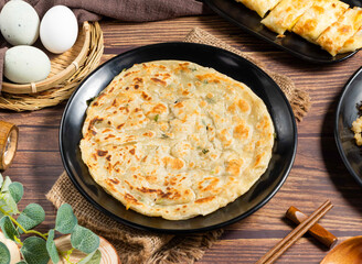 Golden Pan Fried Scallion Pancake on Black Plate side view of hong kong food