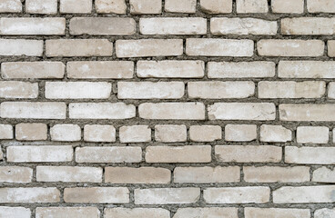 Grey brick wall background with cement seams. Texture close-up.