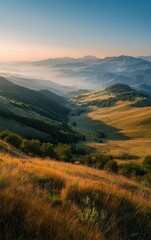 Fototapeta premium Serene sunrise mountain landscape. Golden hour light, mist-covered valley. Ideal for travel, nature, and environmental projects.