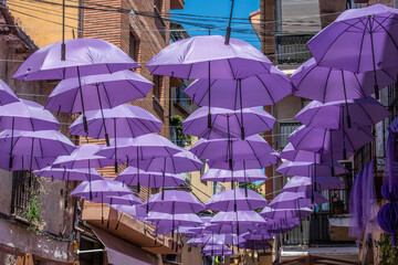 Purple umbrellas decorate a street during the Lavender Festival in Brihuega, Guadalajara province, Spain.