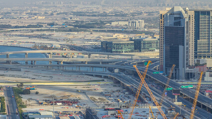 Traffic on a busy intersection in Dubai downtown evening timelapse. Top view from above