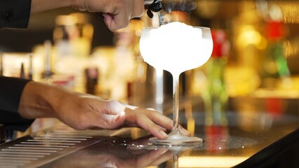 Closeup hand bartender adding sugar or salt to mixed vodka cocktail glass, preparation making special drink menu to VIP guest at front bar luxury. Special refresh drink showcasing nightlife. Vinosity.