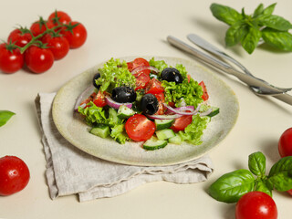 Tomato salad, Greek Salad with Cherry Tomatoes and Basil on Light Background