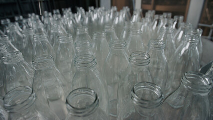 Many empty glass bottles waiting to be filled in