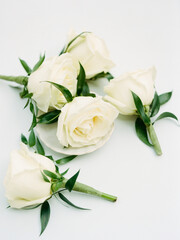 Elegant white roses arranged artistically on a neutral background, showcasing their beauty and delicate features