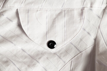 White striped shirt pocket with black button
