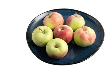 Fresh apples on a dark blue ceramic plate
