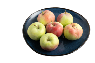 Fresh apples on a dark blue ceramic plate
