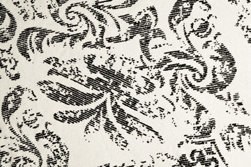 Black floral textile pattern on white fabric
