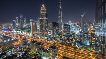 Fototapeta premium Dubai downtown skyline night timelapse with tallest building and road traffic, UAE