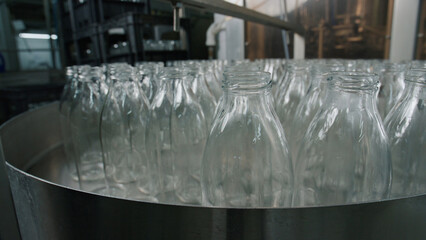 Empty glass bottles passing through quality