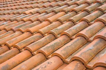 Clay tile roof in hot country, terracotta tiles protecting building from sun, traditional roofing...
