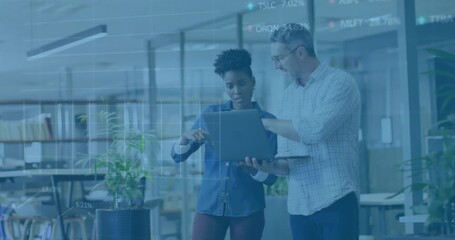 Two colleagues tapping touchscreen and initiating overlays while exchanging financial insights - Powered by Adobe