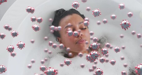 Woman settling upright in foam bathtub and activating swirling virus graphic during health demo - Powered by Adobe