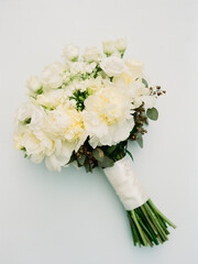 Elegant white flower bouquet arranged for a wedding ceremony on a light background