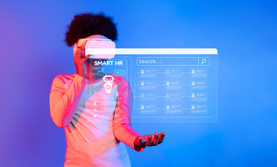 A person explores smart HR technology using virtual reality in an innovative workspace. The vibrant...