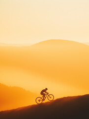 Obraz premium Mountain biker conquers golden hills at sunset, embracing adventure and nature's beauty