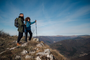 Hikers reaching mountain top enjoying scenic view