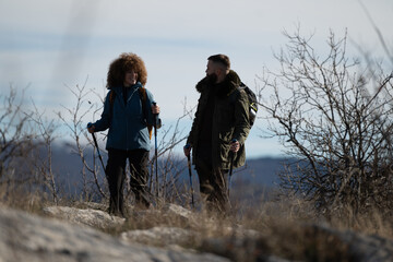 Hikers walking and talking on mountain top in winter