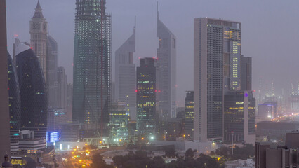 Dubai downtown skyline night to day aerial timelapse with traffic on highway