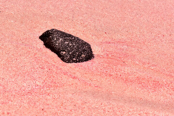 Pink sand on the beach, composed of grains of red coral, close-up, top view