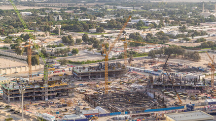 Construction activity in Dubai downtown with cranes and workers timelapse, UAE.