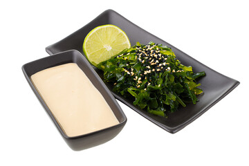 a plate of food with a lime and sauce