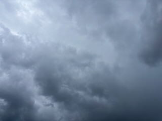 Fototapeta premium Dark stormy clouds in grey sky, overcast weather background before rain or thunderstorm, dramatic atmospheric scene, concept of meteorology, climate change, weather forecasting