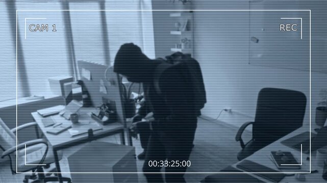 Security camera footage of two masked men sneaking into office aiming to steal confidential corporate data then one criminal covering surveillance camera with adhesive tape blinding security system