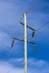 Photograph of the top cable section of an old style wooden electricity transmission line support pole typically used in regional parts of Australia.