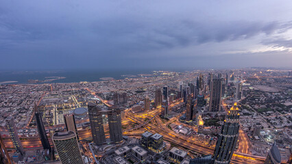 Fototapeta premium Downtown of Dubai night to day timelapse before sunrise. Aerial view with towers and skyscrapers