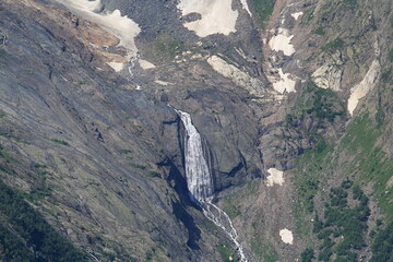Waterfalls from melting snow in the mountains of Elbrus region in Dombai