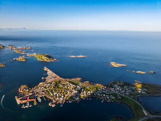 Aerial view of a coastal village on the Lofoten Islands in Norway, surrounded by ocean and small...