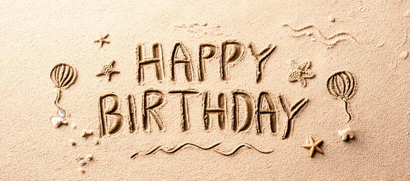 Happy Birthday Written Playfully in Beach Sand with Doodles of Stars and Waves – Fun Wide Composition for Celebration Graphics or Seasonal Cards