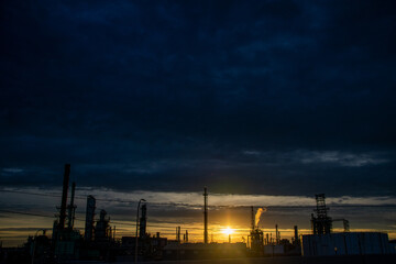 Sunset silhouettes at oil refinery Detroit Michigan 