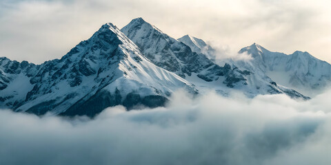 Obraz premium Snowy mountain peaks rising from dense morning fog