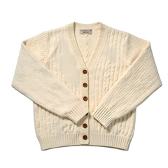 Cozy off white cable knit cardigan with wooden buttons sleeves gracefully crossed perfect for a timeless and sophisticated look