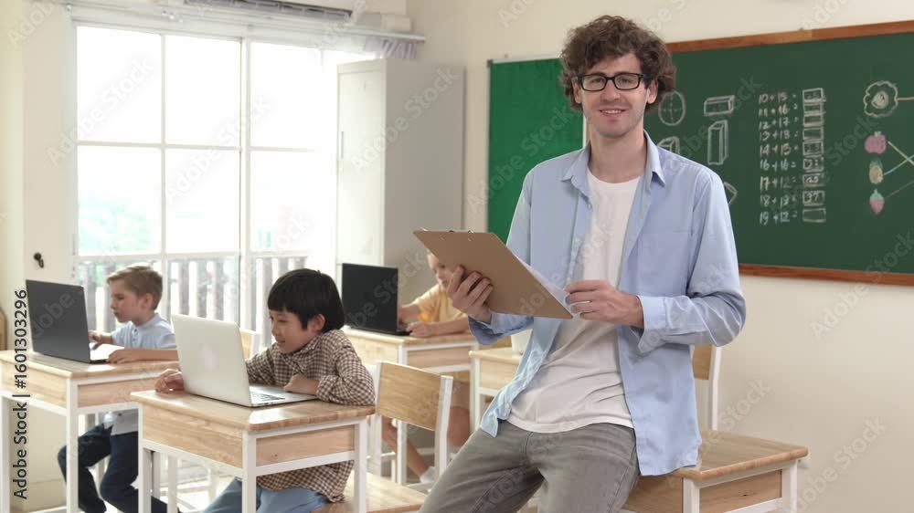 Poster caucasian teacher checking document and looking at camera at classroom. diverse children sitting at 