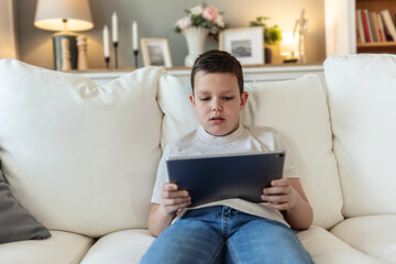 Cute boy, streaming and smartphone for educational games, growth and development in home. Kids, mobile tech and esports for creativity, fun and social media with application, download and playing.